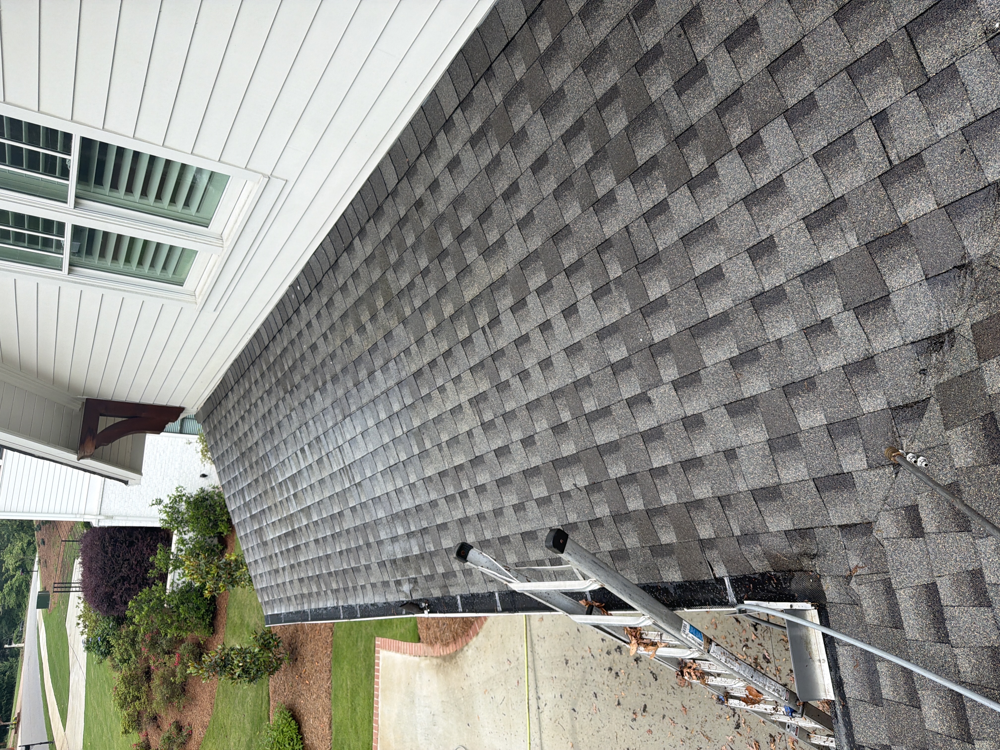 Clean asphalt shingle roof slope after soft wash cleaning on a residential home in Marietta, GA