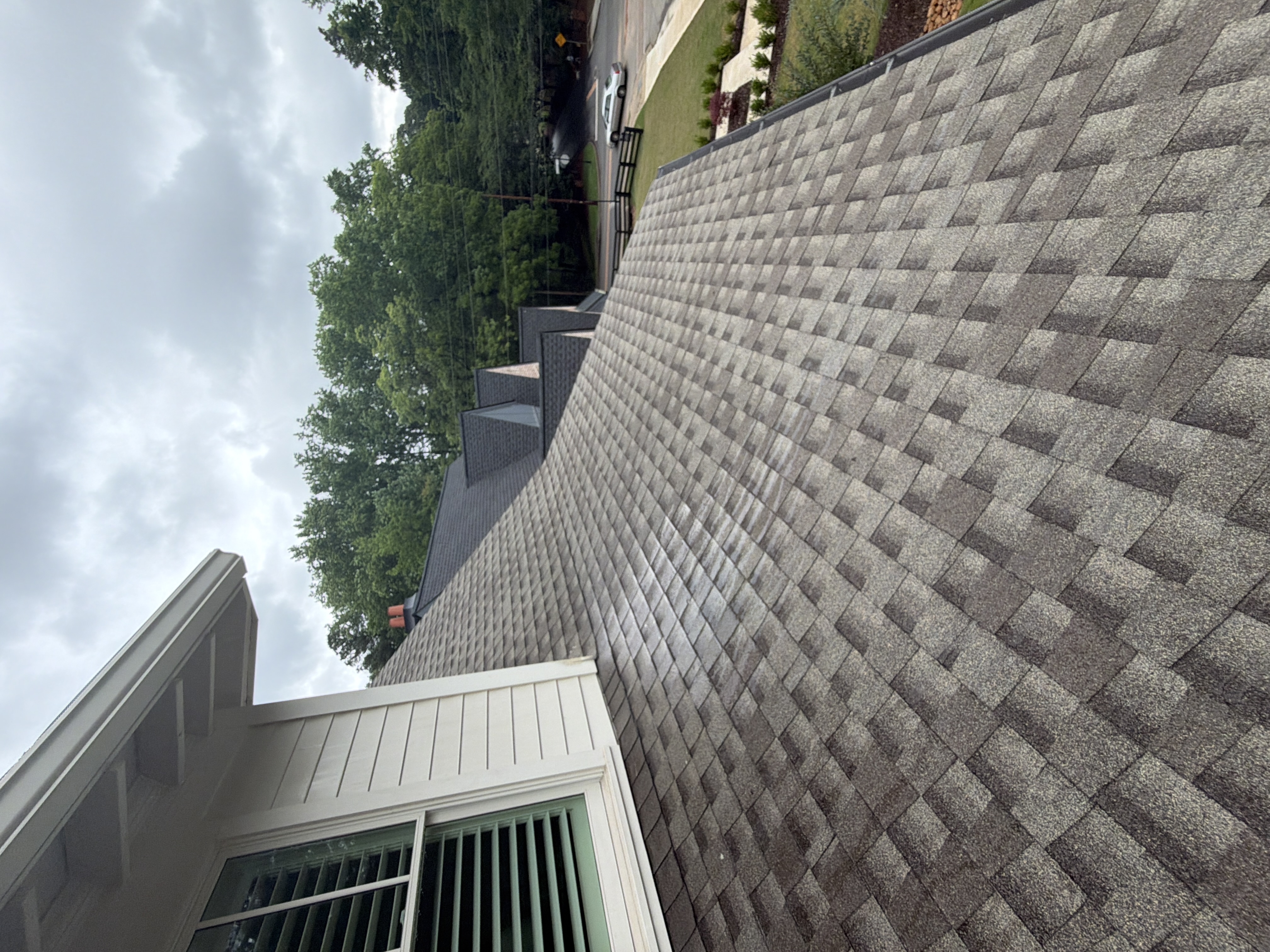 Freshly cleaned asphalt shingle roof on residential home in Marietta, GA showing full slope after service