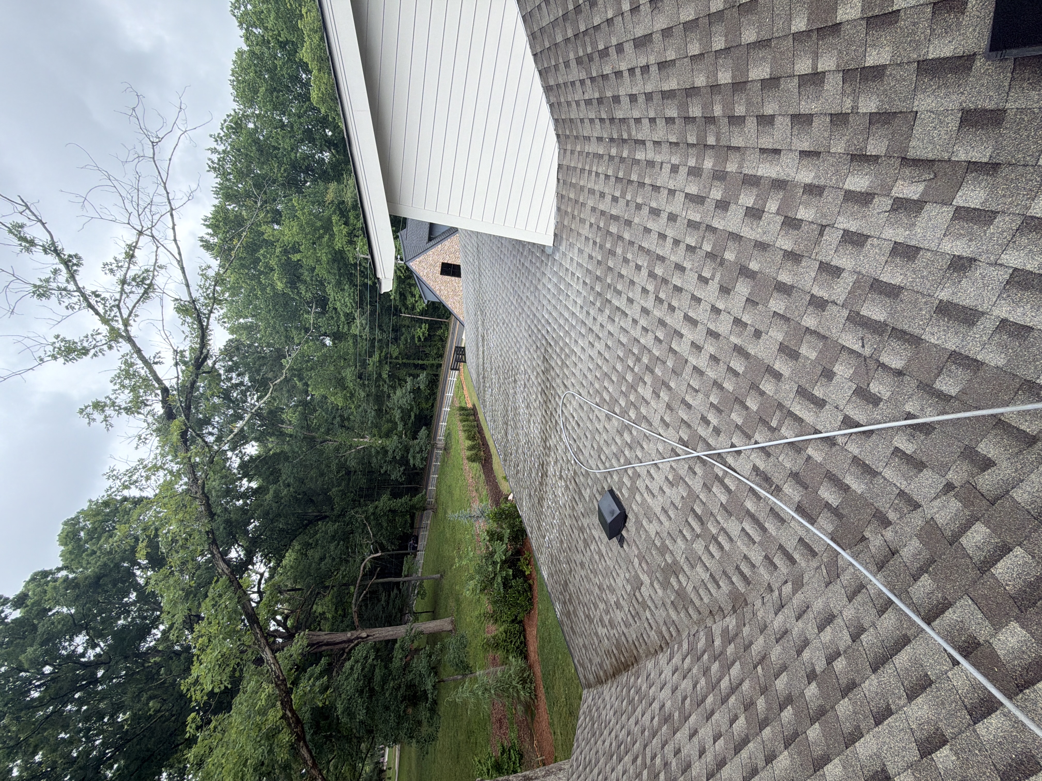 Clean rear asphalt shingle roof slope after soft wash cleaning on a residential home in Marietta, GA