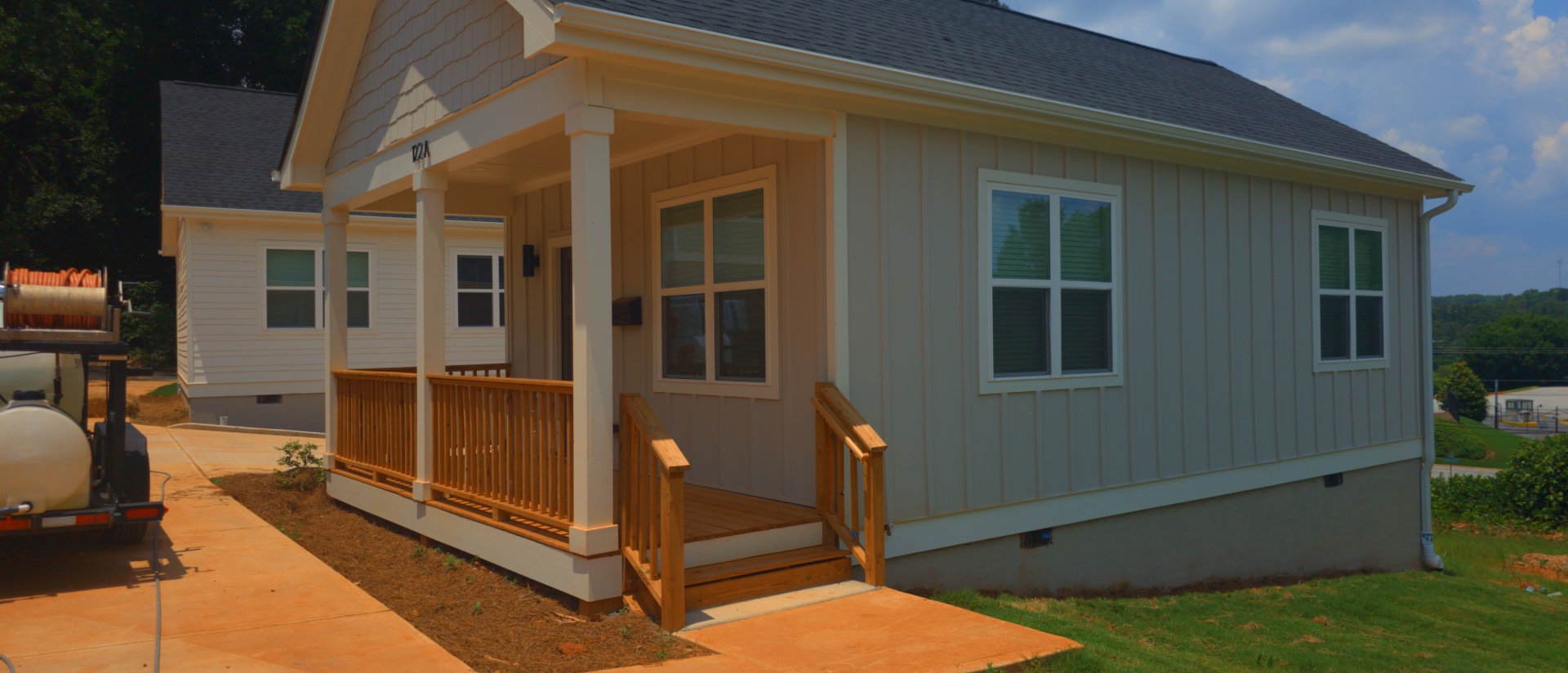 Gray board-and-batten siding on a new construction home with covered front porch at a pressure washing job in Atlanta, GA.