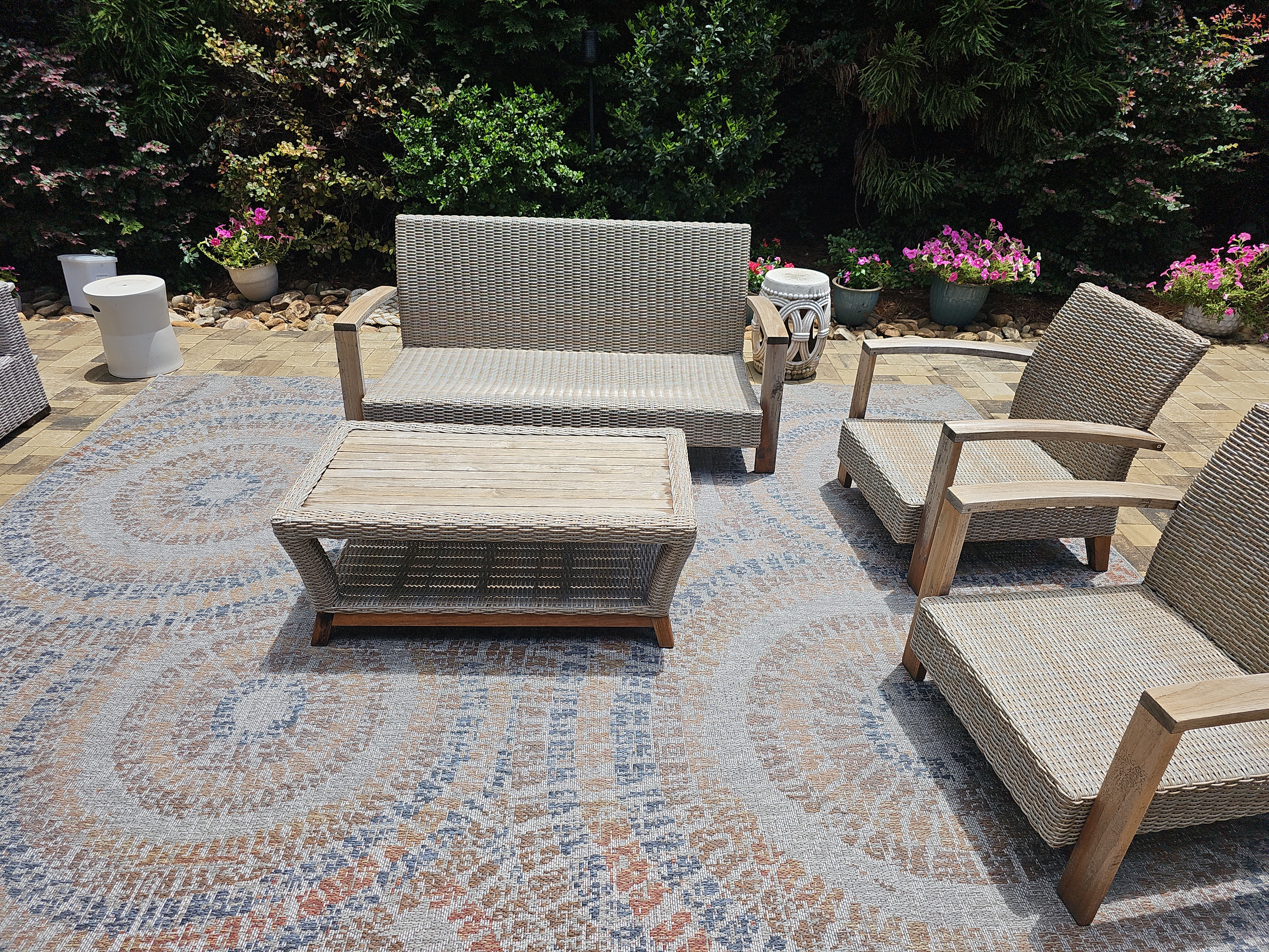 Wicker lounge set on a patterned outdoor rug over a paver patio at a Marietta, GA pressure washing job.