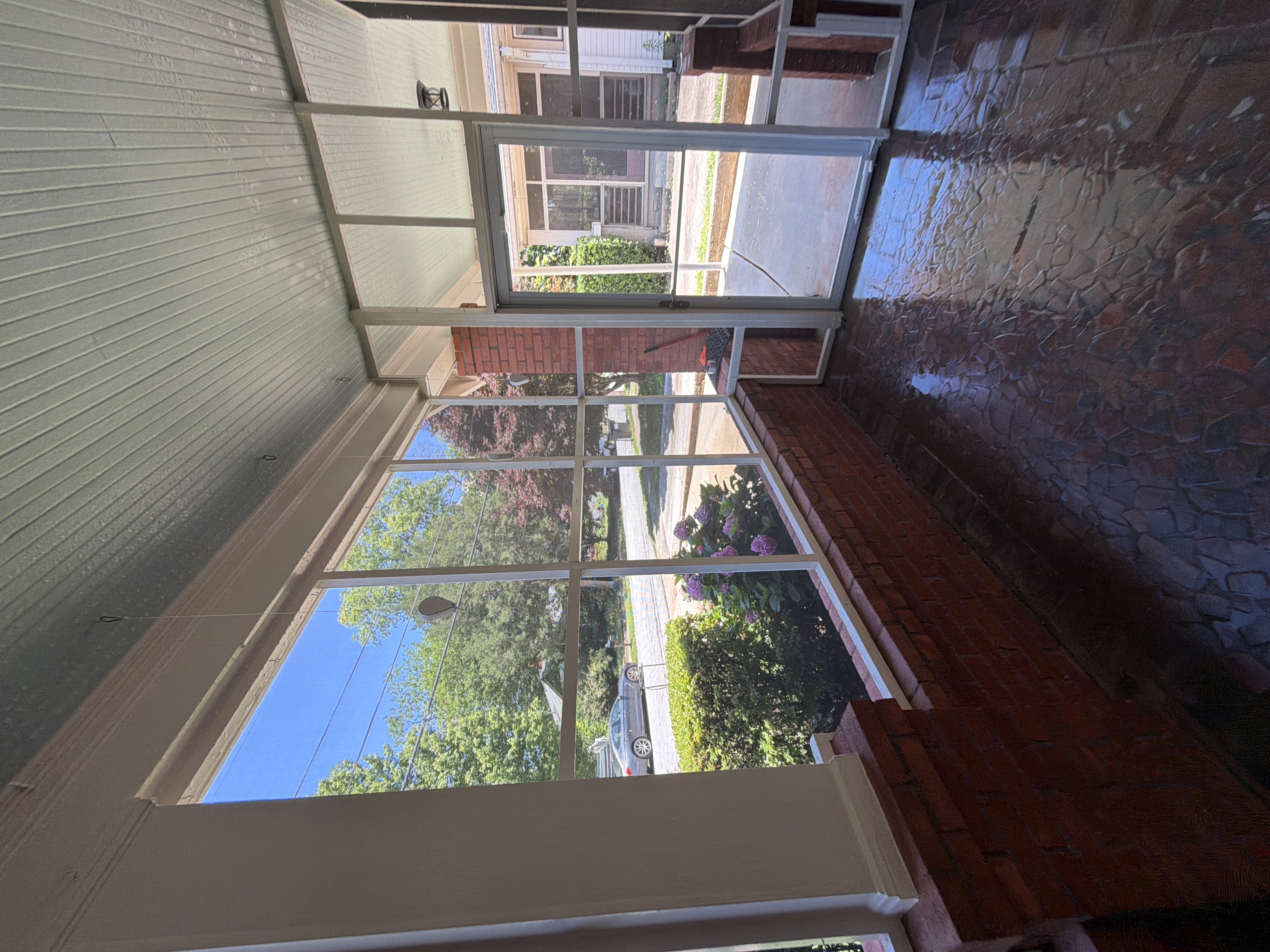 Screened porch mosaic floor glistening clean after pressure washing at a home in East Point, GA
