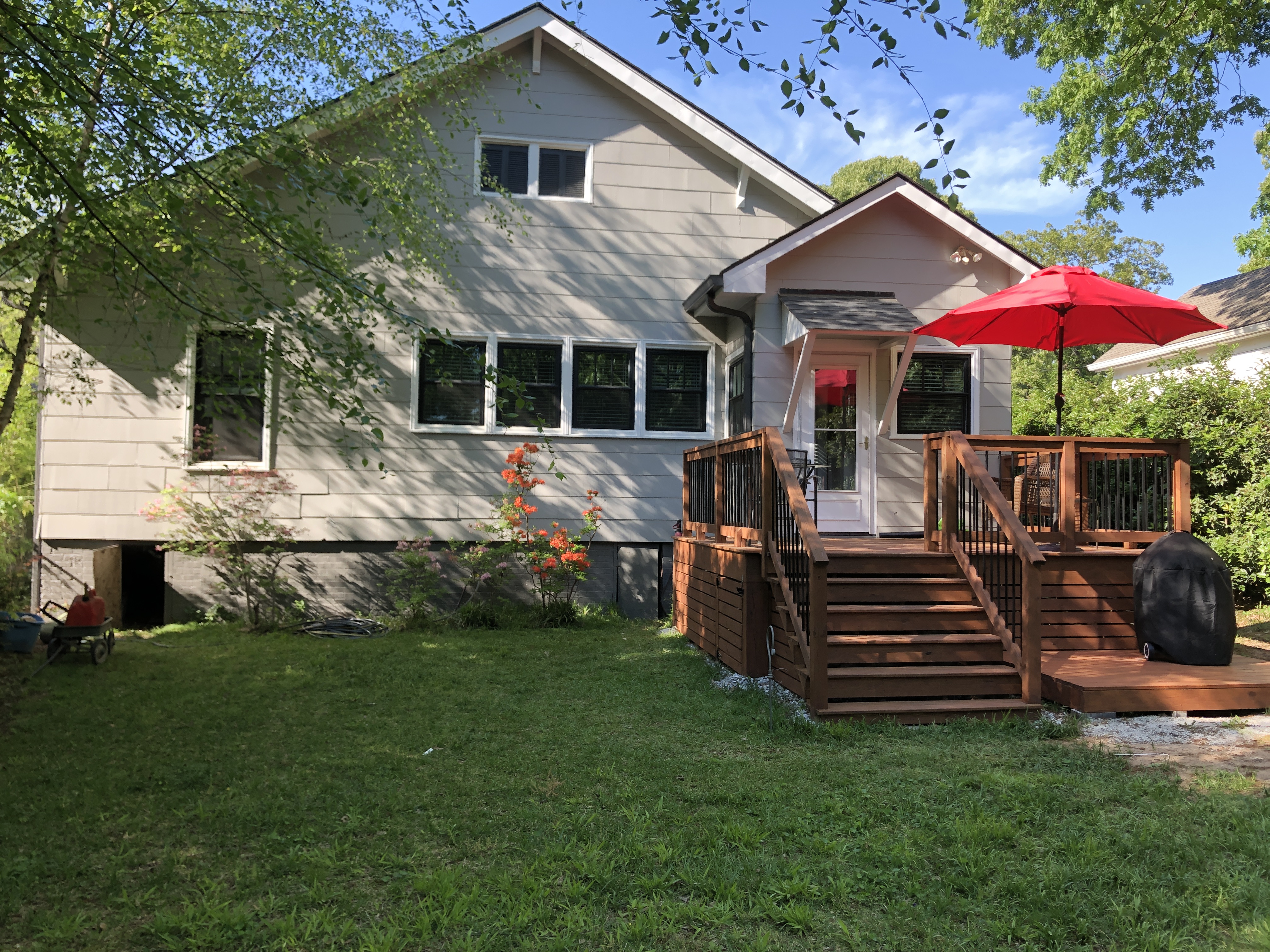 Wood deck and gray siding on a residential home in East Point, GA after soft washing and deck cleaning by Alpha Pressure Washing.
