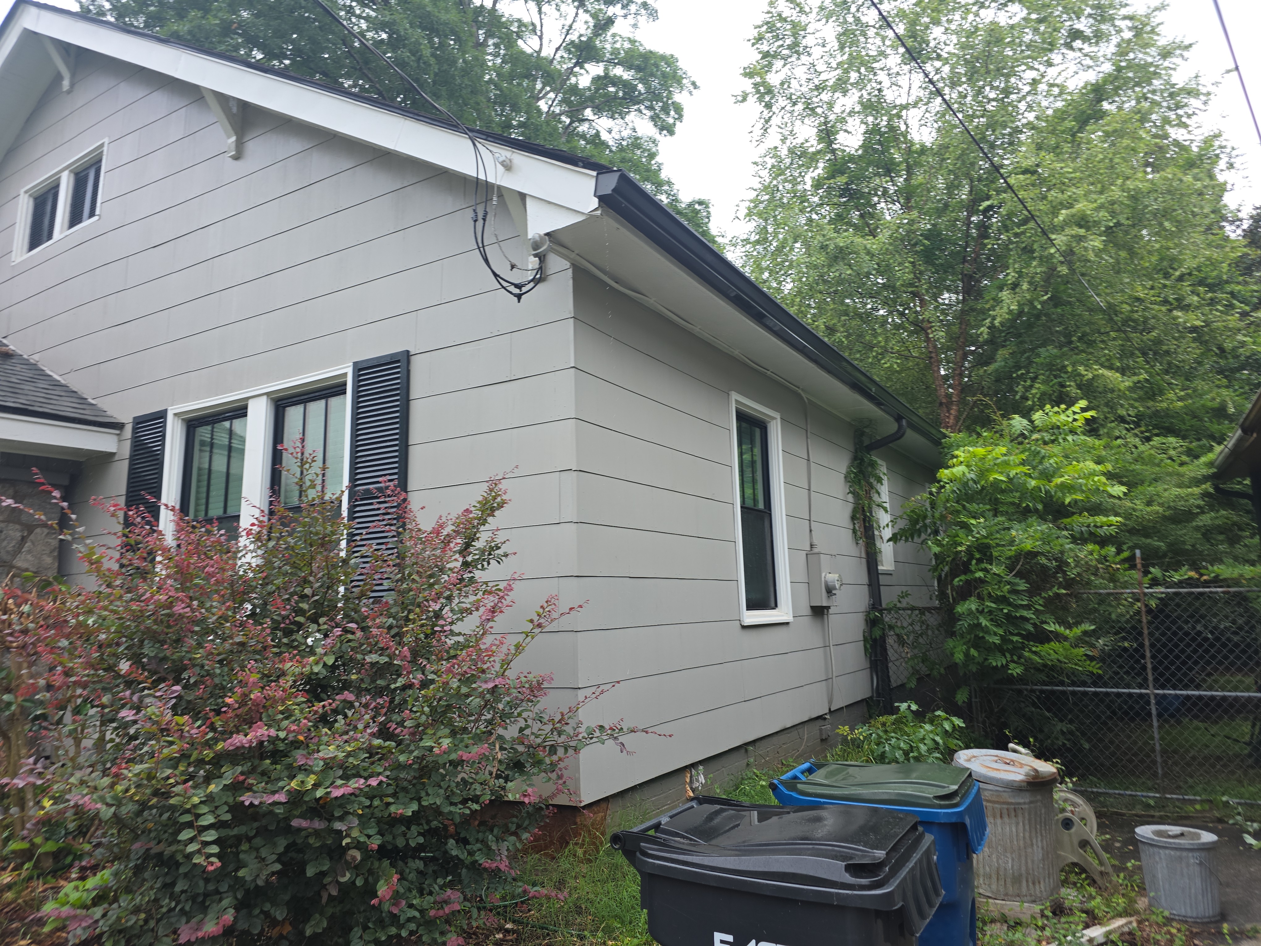 Clean gray vinyl siding on the rear corner of a craftsman home after house washing service in East Point, GA