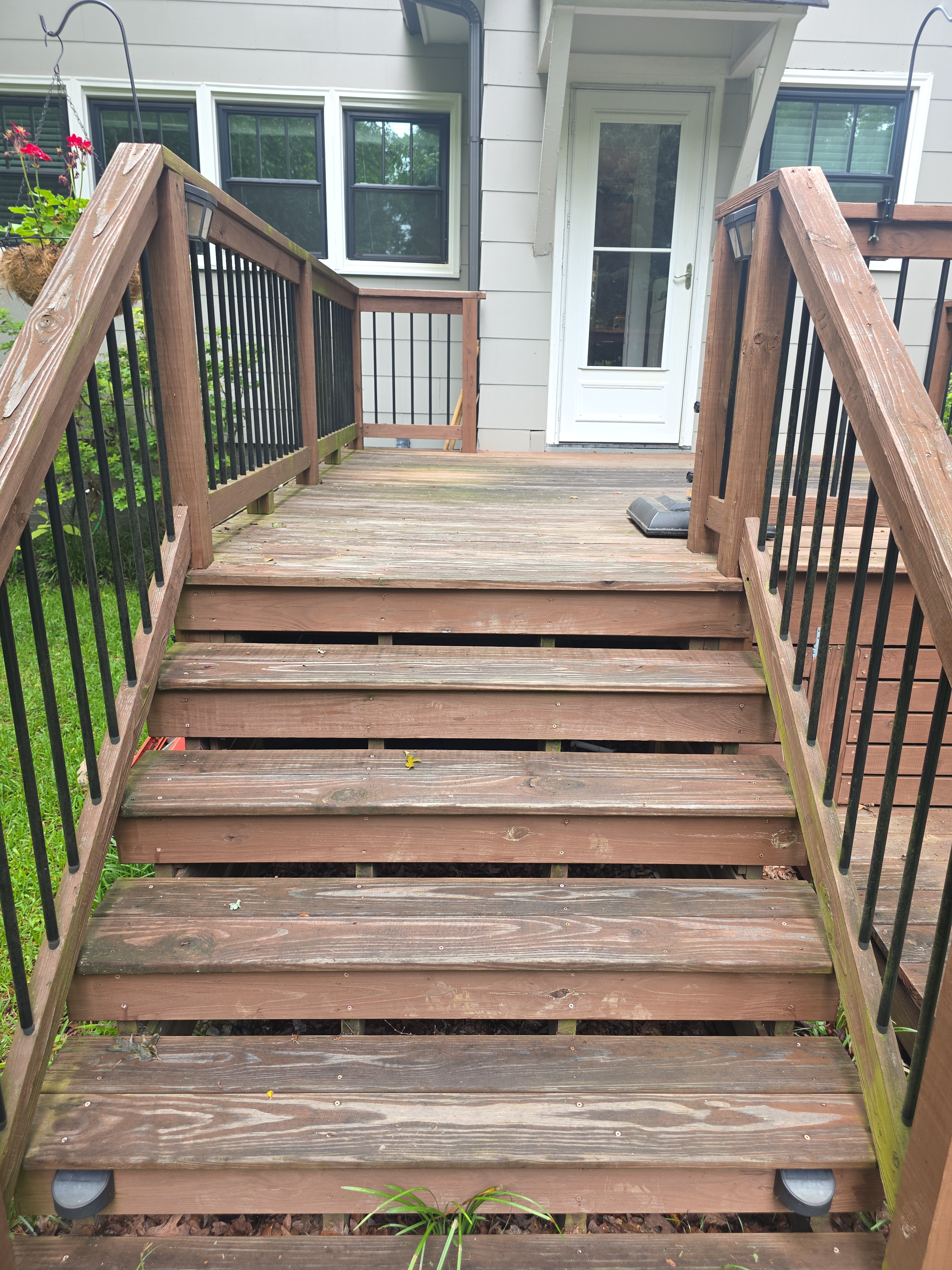 Weathered wood deck stairs with algae and discoloration before pressure washing at a residential home in East Point, GA