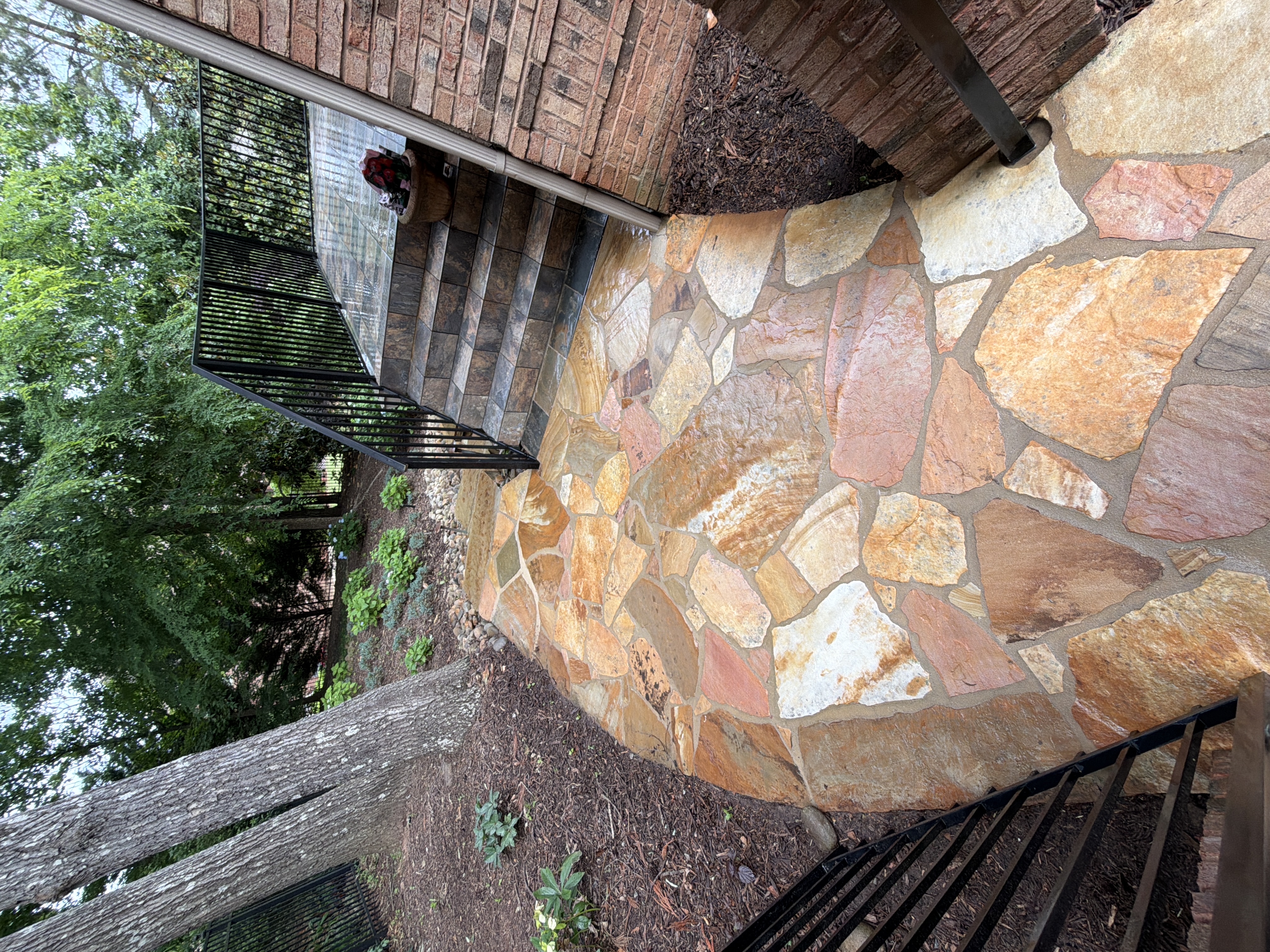 Flagstone walkway and stone steps after pressure washing at a Duluth, GA home, with the path leading toward the patio.