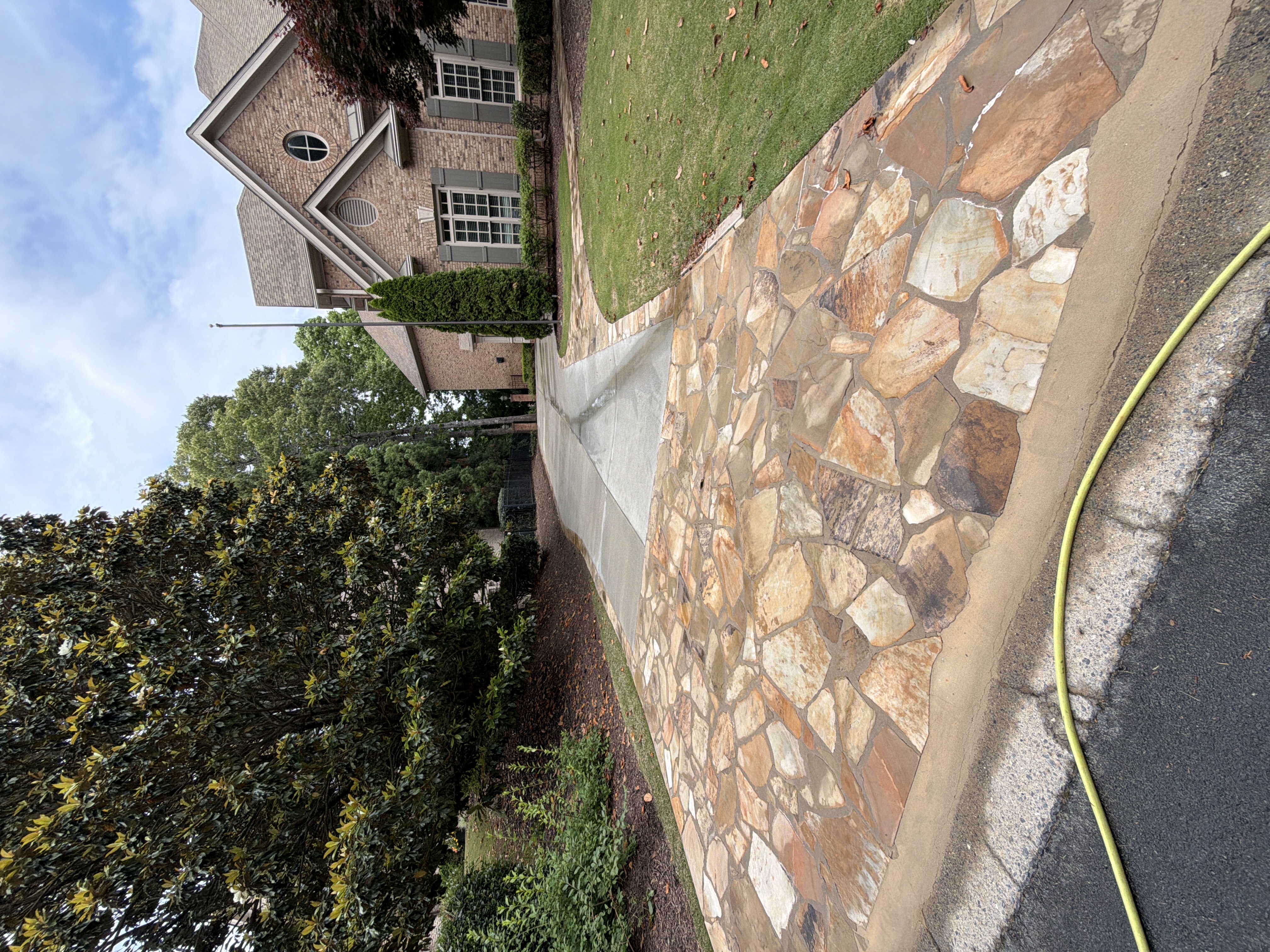 Flagstone driveway apron and concrete driveway at a large brick home in Duluth, GA pressure washing job.