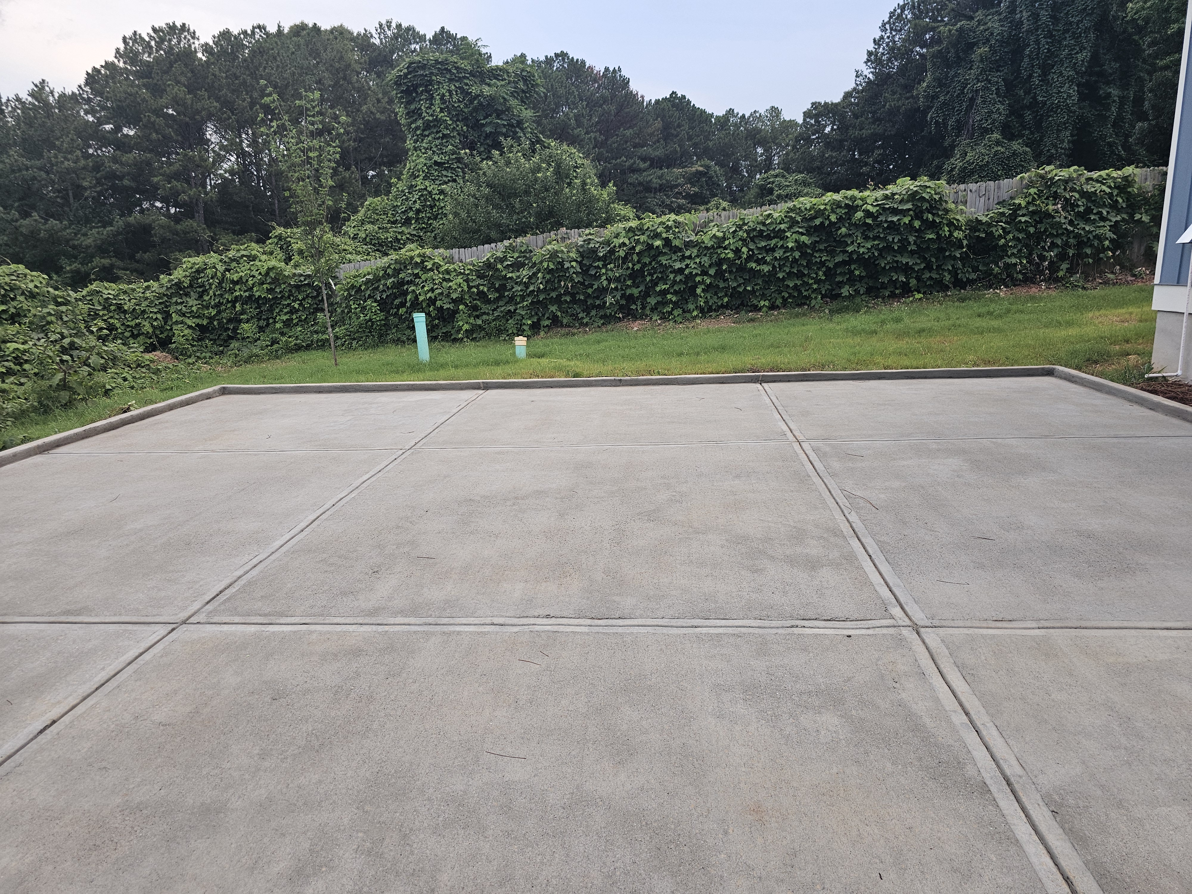 Concrete pad at the rear of a new construction home after pressure washing in Atlanta, GA.