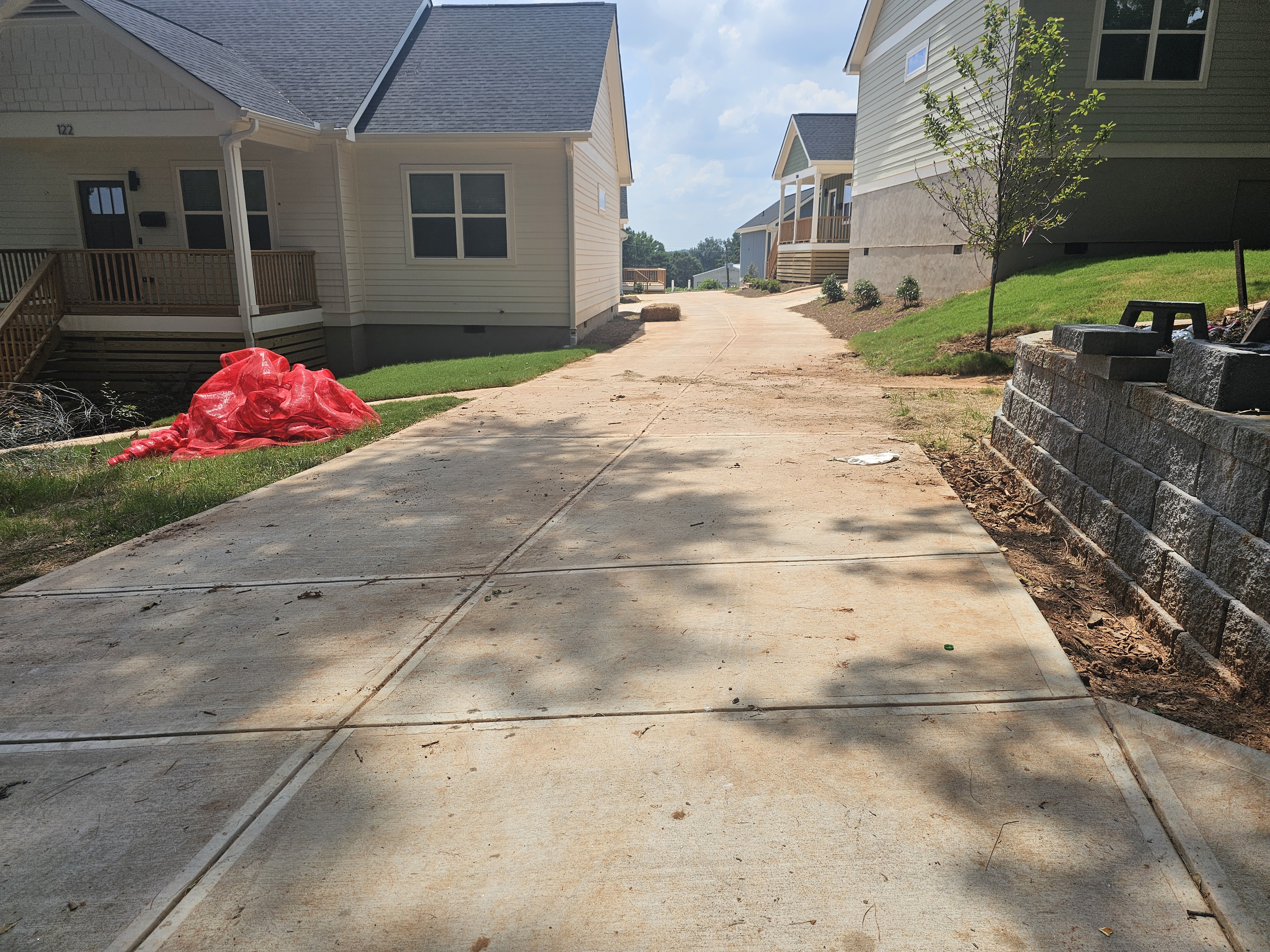 Concrete driveway running between new construction homes at a pressure washing job in Atlanta, GA.