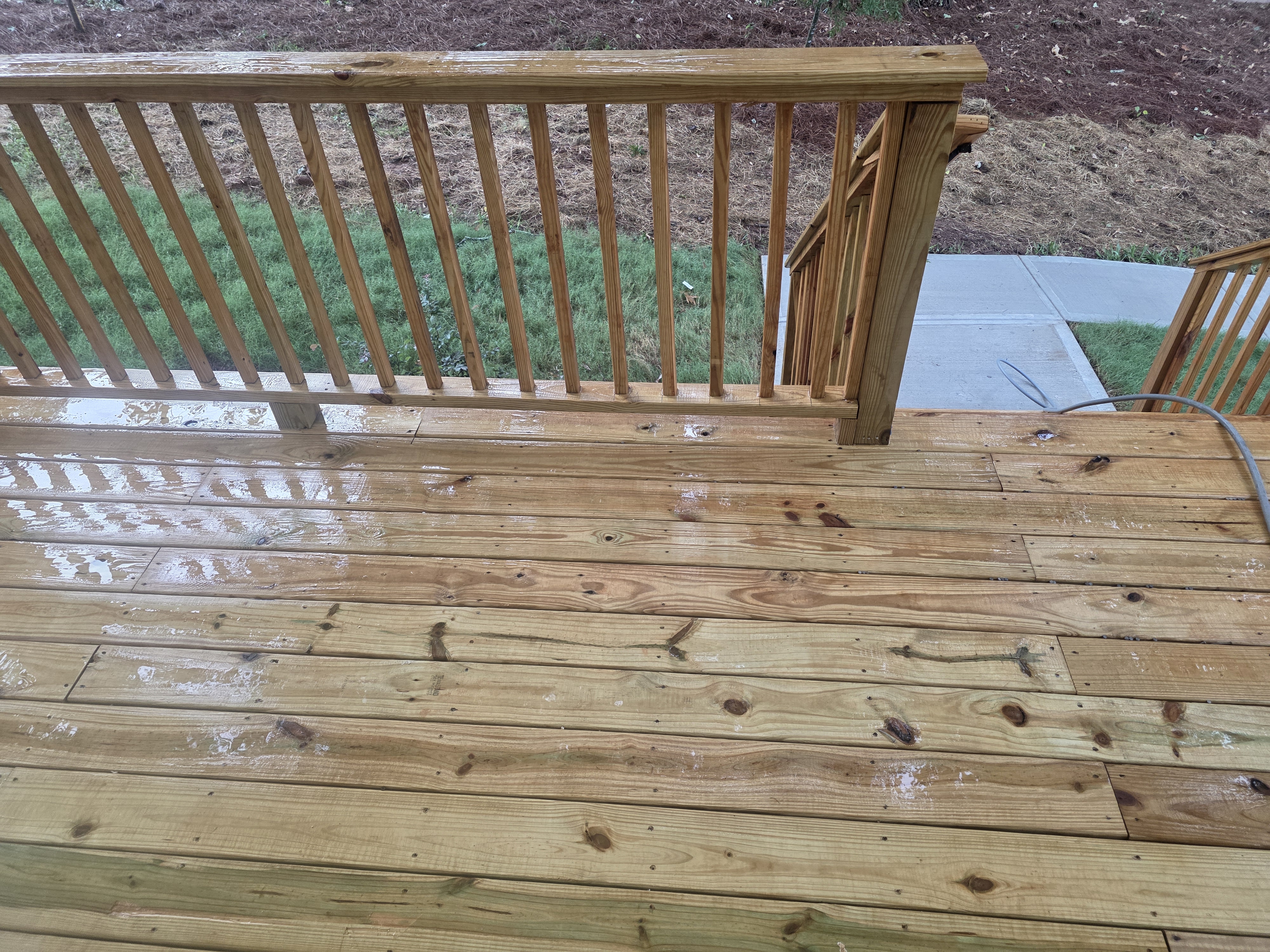 Wood deck with spindle railing after pressure washing at a new construction home in Atlanta, GA.