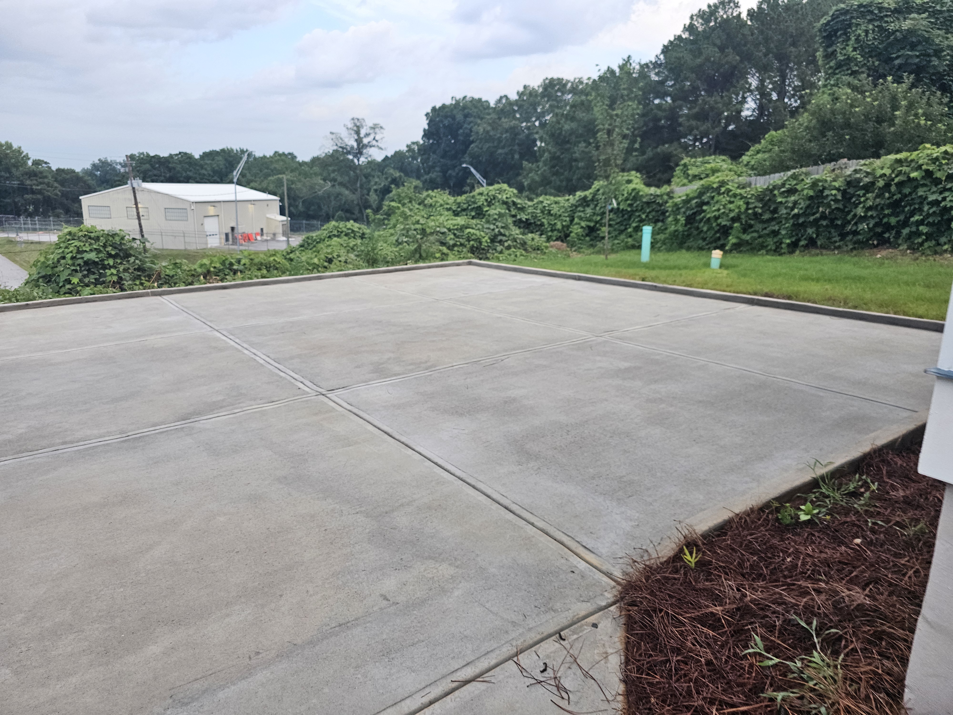 Large concrete pad at the rear of a new construction home after pressure washing in Atlanta, GA.