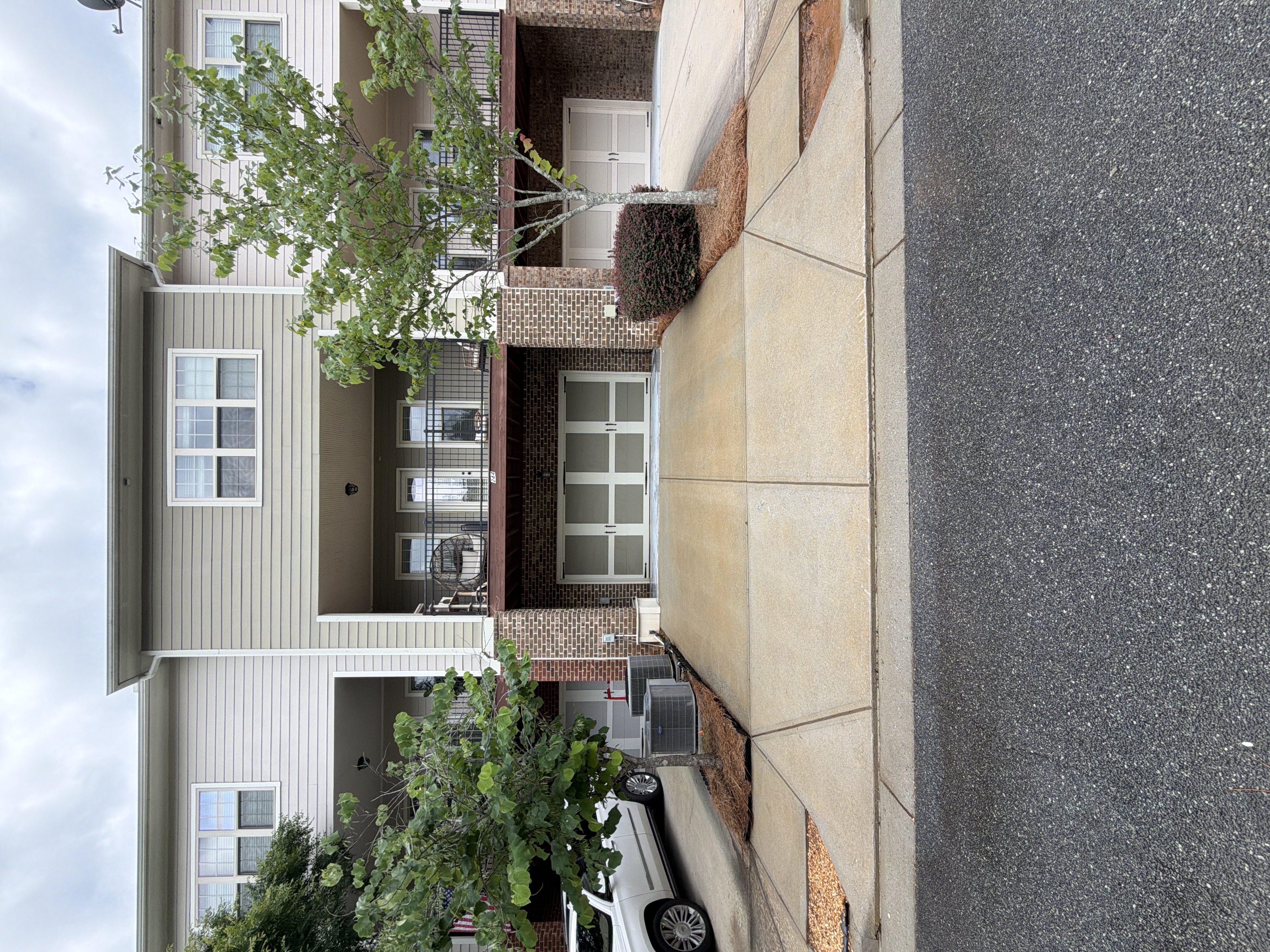 The front of the house with the cleaned driveway and garage door.