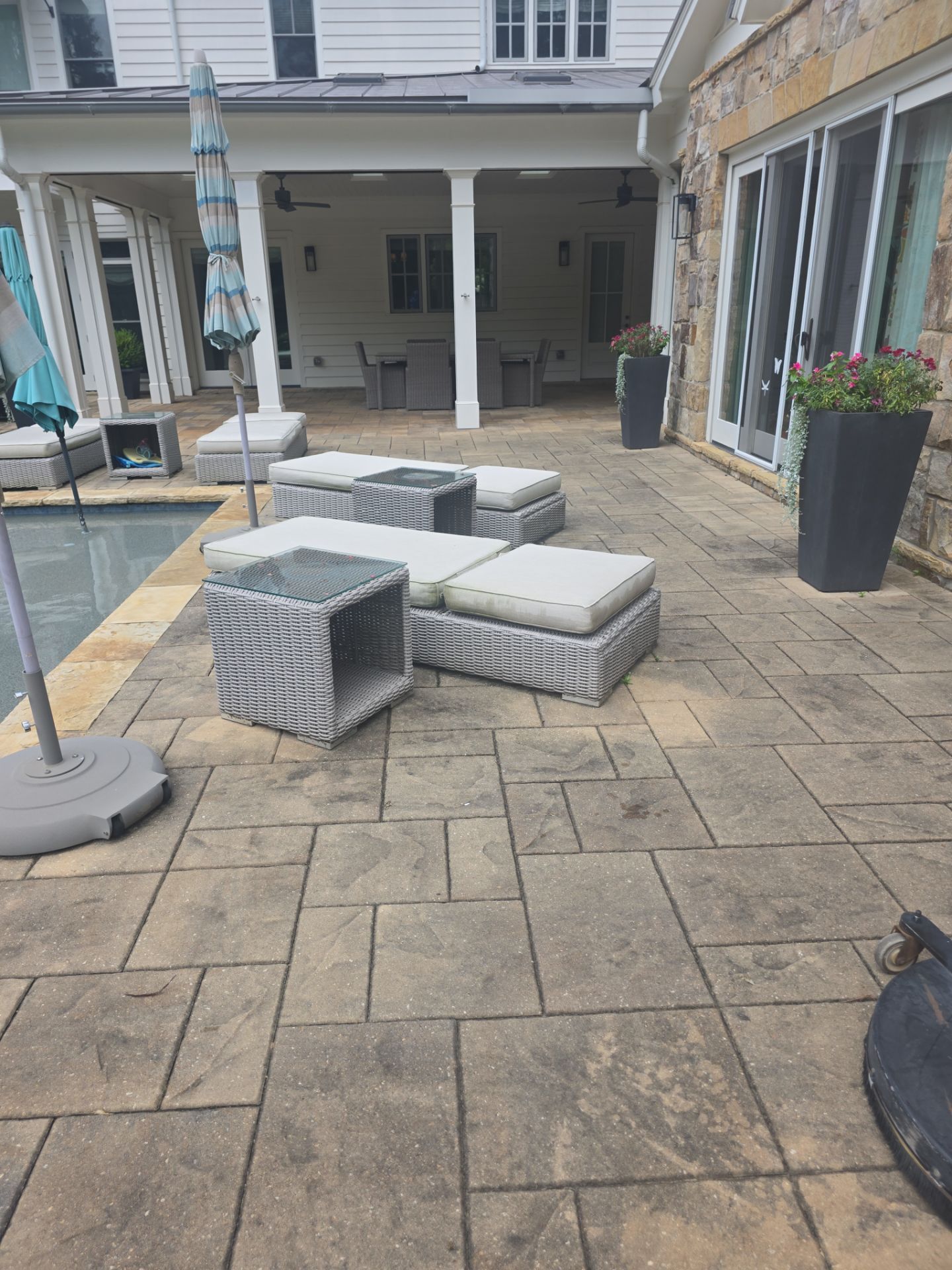 Stamped concrete pool deck with outdoor lounge furniture beside a pool at a Milton, GA residence.