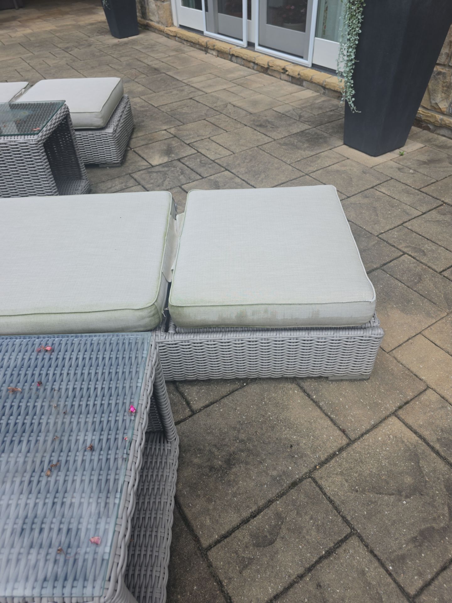 Outdoor wicker furniture on a stamped concrete patio at a Milton, GA residence during a pressure washing visit.