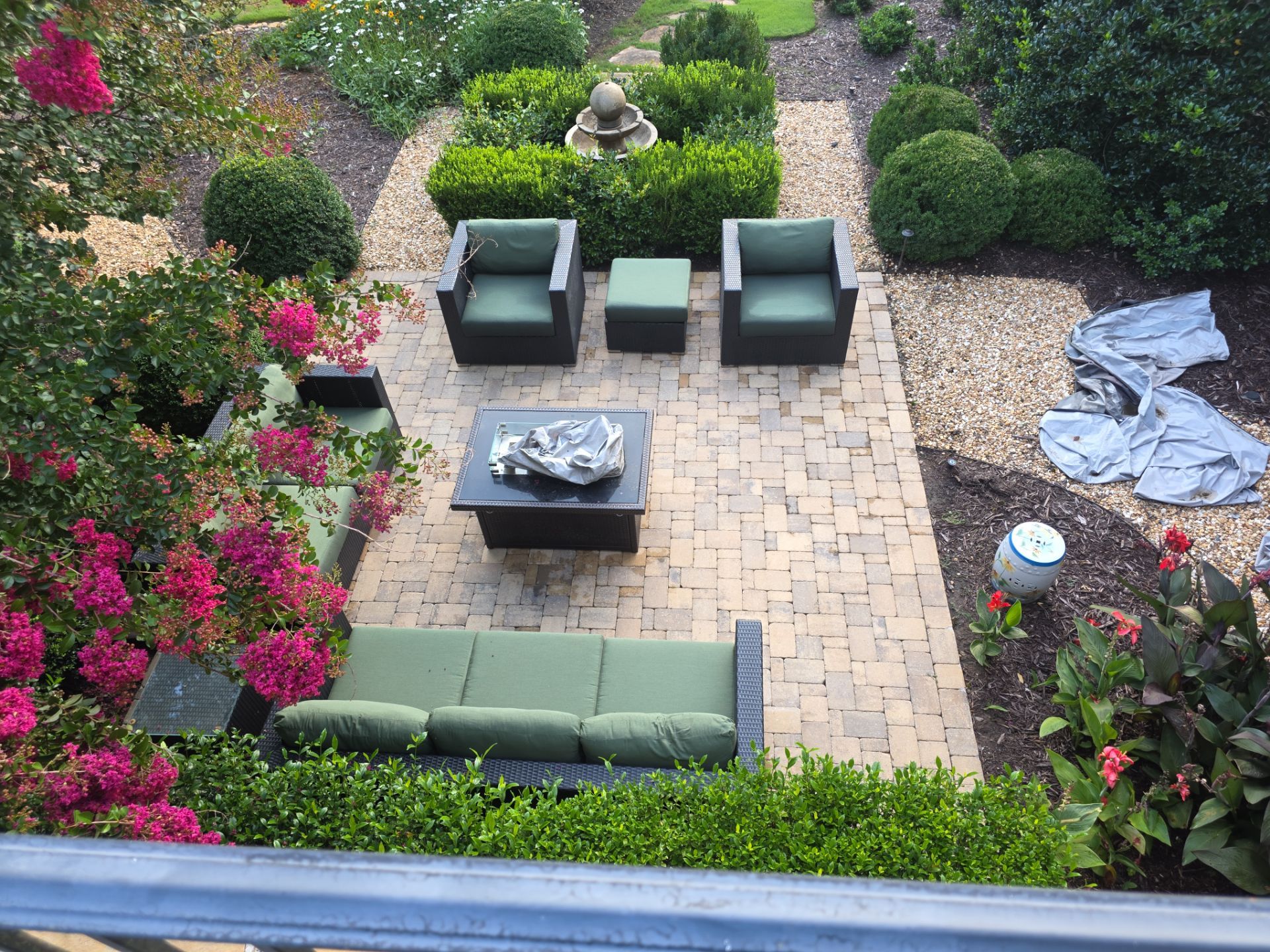 Elevated view of a brick paver patio surrounded by formal boxwood garden and crepe myrtles at a Milton, GA home.