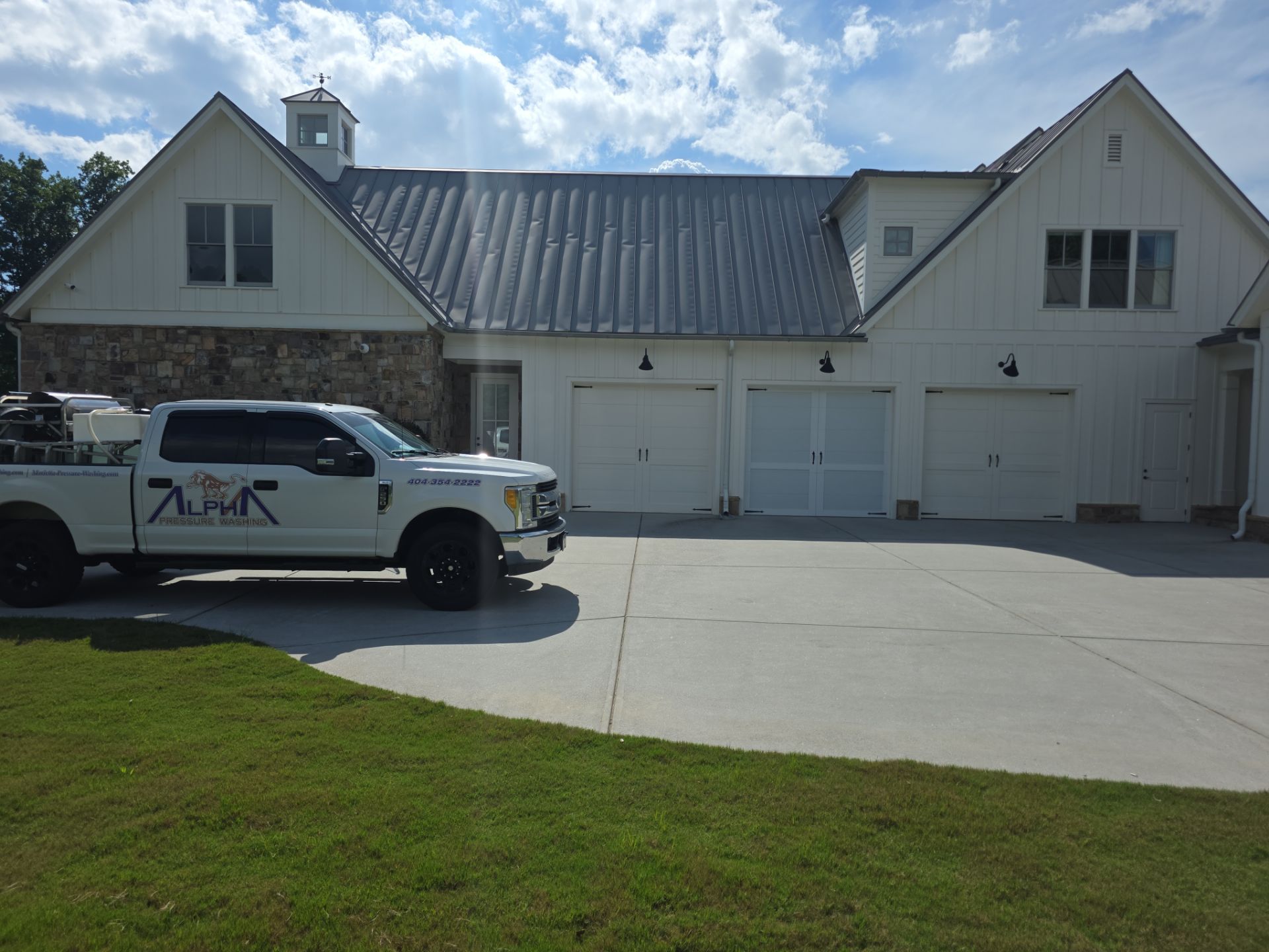 Alpha Pressure Washing truck parked in front of a white board-and-batten farmhouse garage in Milton, GA.